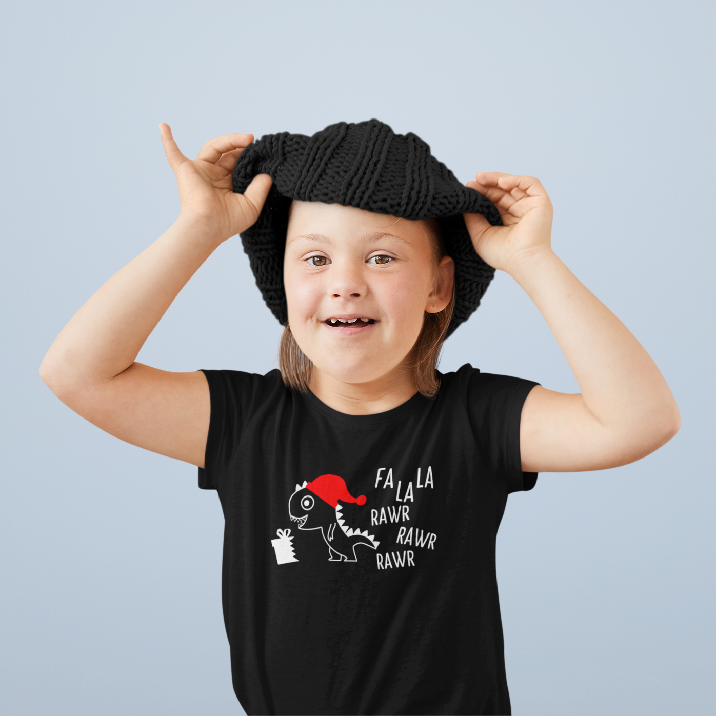 Girl with down syndrome wearing black beanie and black shirt with dino 'Fla La La Rawr Rawr Rawr' print by KMLeon.