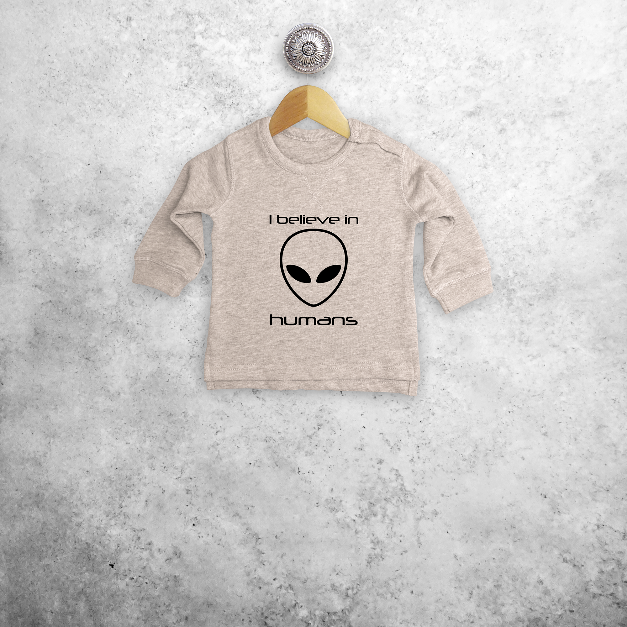 'I believe in humans' baby sweater