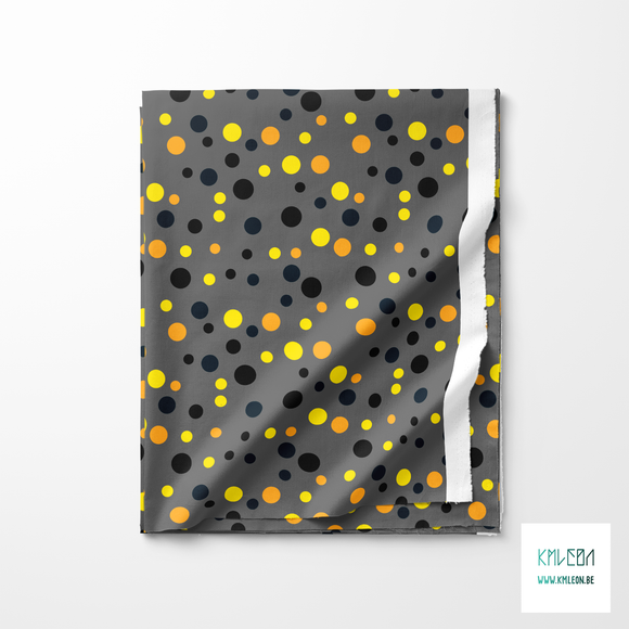 Random orange, yellow, black and dark teal polka dots fabric
