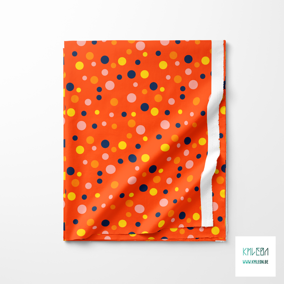 Random pink, yellow, orange and navy polka dots fabric