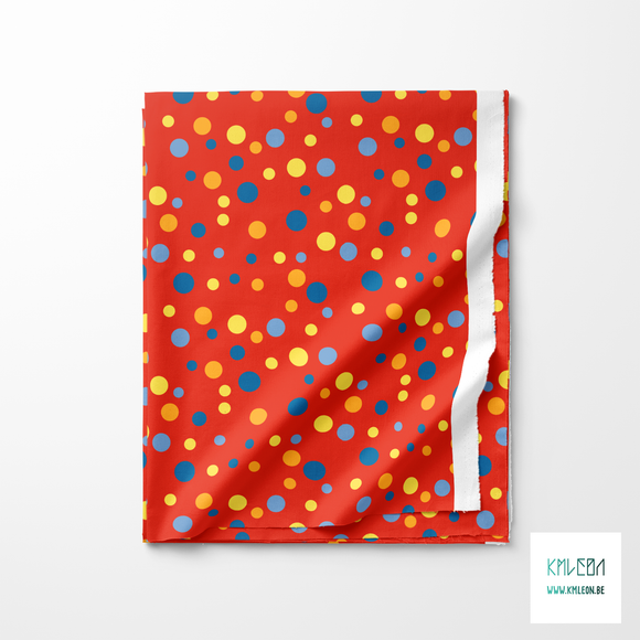 Random yellow, blue and orange polka dots fabric