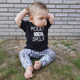 'Models don't smile' baby shortsleeve shirt