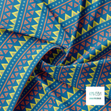 Green, yellow, coral, orange and blue circles and triangles fabric