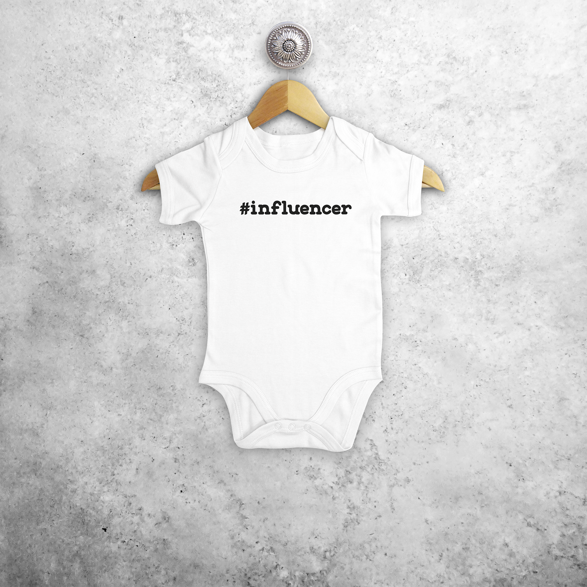 Baby or toddler bodysuit with short sleeves, with '#influencer' print by KMLeon.