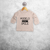 'Models don't smile' baby sweater