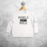 'Models don't smile' kids sweater