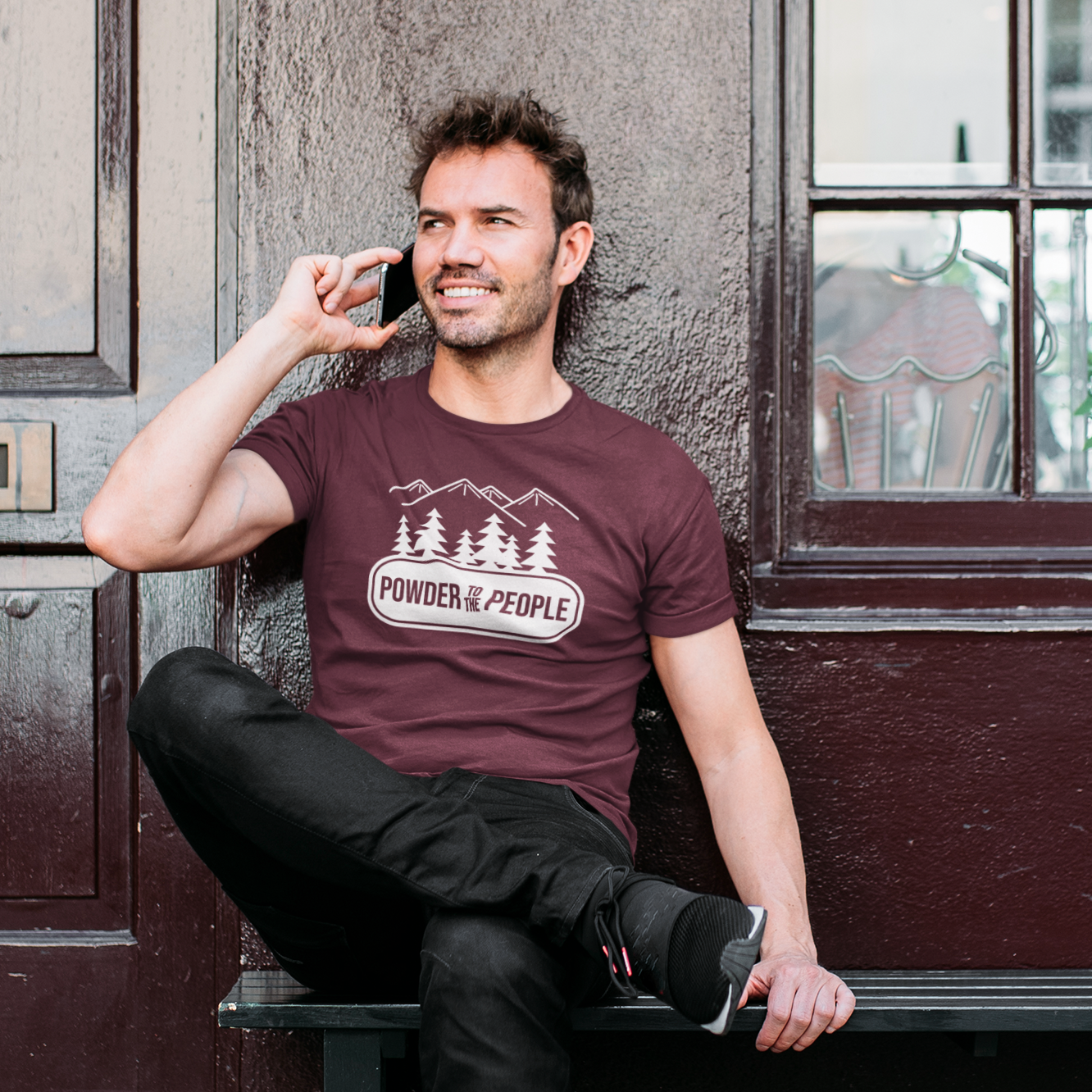 MMan calling on phone, wearing burgundy shirt with 'Powder to the people' print by KMLeon.