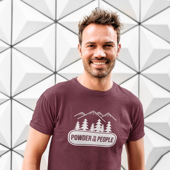 Smiling man in front ogf white graphic wall, wearing burgundy shirt with 'Powder to the people' print by KMLeon.