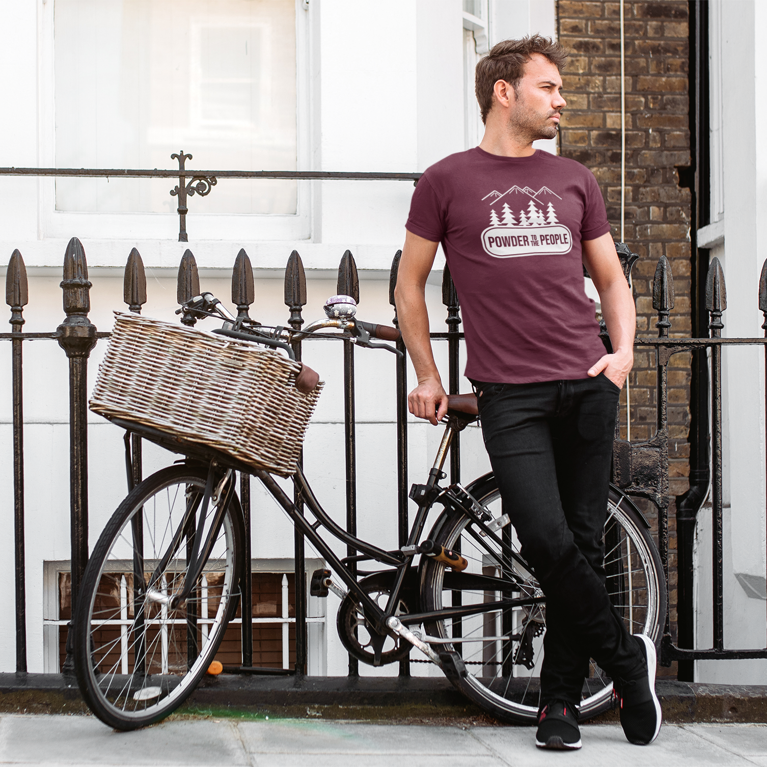 Man with bike, wearing burgundy shirt with 'Powder to the people' print by KMLeon.
