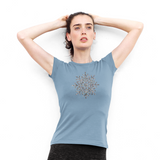 Woman wearing indigo shirt, with glitter snow star print by KMLeon, tying hair.