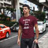Man walking in city wearing burgundy shirt with 'Waiting for snow' print by KMLeon.